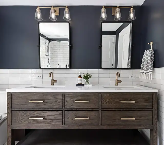 Primary bathroom remodel in Ann Arbor with navy walls, white subway tile, dark oak double vanity and black-framed mirrors