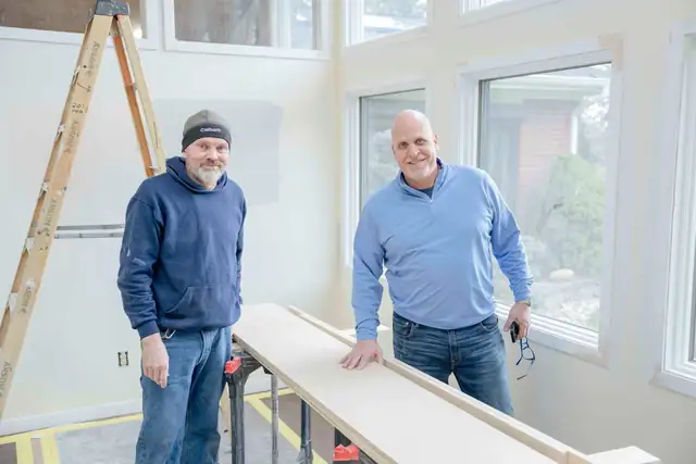 Jef Forward, President and Creative Director, meeting on a job site with lead carpenter Jeff